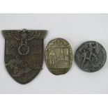 A WWII German Krim shield and two day badges.