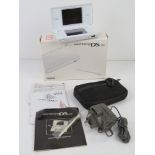 A Nintendo DS lite in box complete with More Brain Training game, charger cable, case, untested.