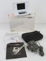 A Nintendo DS lite in box complete with More Brain Training game, charger cable, case, untested.
