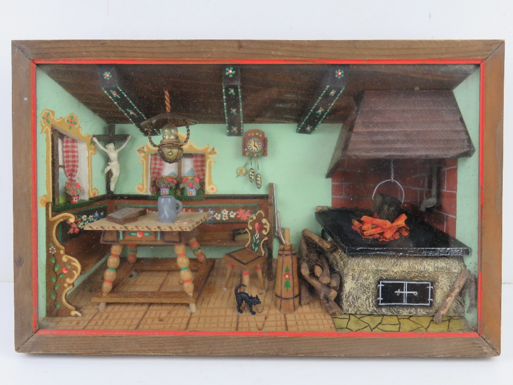 A Swiss musical movement diorama of a kitchen with floral decorated pew type bench and fireplace.