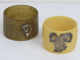 Two napkin rings; one horn napkin ring with HM silver shield shaped cabachon bearing the letter D,