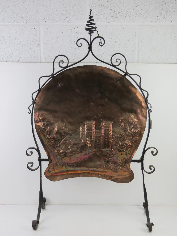 An Arts & Crafts wrought iron and beaten copper fireguard 'Layer Marni Tower Essex' 57cm wide,