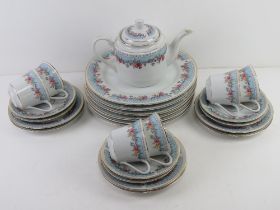 A floral chintz tea and dinner service comprising teapot, cups, bowls, plates etc.