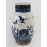A blue and white Oriental style vase having cranes and floral pattern upon, 28cm high.