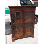 An Edwardian mahogany twin door floorstanding display cabinet,