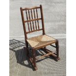 A spindle turned Lancashire style rush seated country made rocking chair.