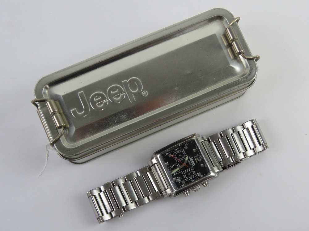 A stainless steel Jeep wristwatch in presentation tin, glass showing signs of use.