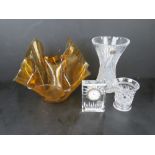 A Waterford crystal clock together with a handkerchief vase and two cut glass vases. Four items.