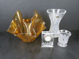 A Waterford crystal clock together with a handkerchief vase and two cut glass vases. Four items.