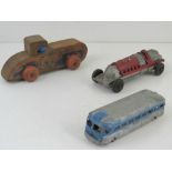 An American made cast metal racing car toy together with Greyhound Line bus and wooden US Scout toy