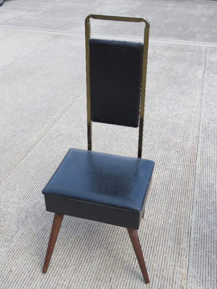 A mid century gentleman's chair, having lift up seat opening to reveal compartment within,