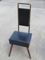 A mid century gentleman's chair, having lift up seat opening to reveal compartment within,