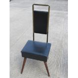 A mid century gentleman's chair, having lift up seat opening to reveal compartment within,