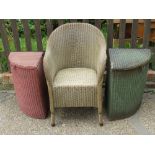 A pair of Lloyd Loom W Lusty & Sons Ltd laundry baskets in green and red respectively.
