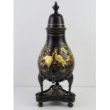 A 19thC pewter Dutch tole and Japanned tea urn of pear shape with an urn finial,