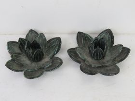 A pair of cast metal floral candle holders approx 11cm dia.