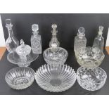 A quantity of assorted cut glass decanters and fruit bowls, etc. Also a ceramic Gin collar label.