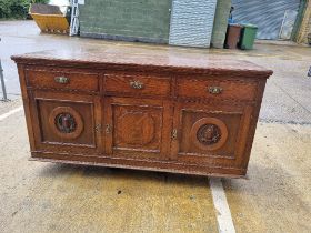 A late Victorian / Edwardian dresser base having three drawers each with vrass handles and