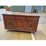 A late Victorian / Edwardian dresser base having three drawers each with vrass handles and