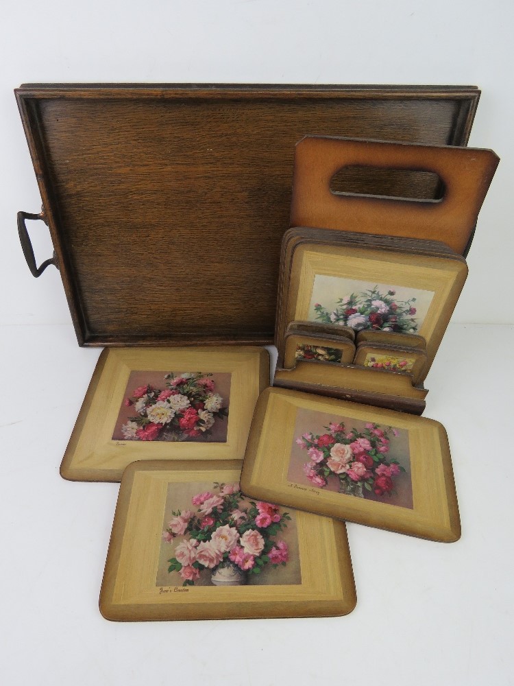 An oak serving tray measuring 46cm wide together with a set of place mats of floral design for six
