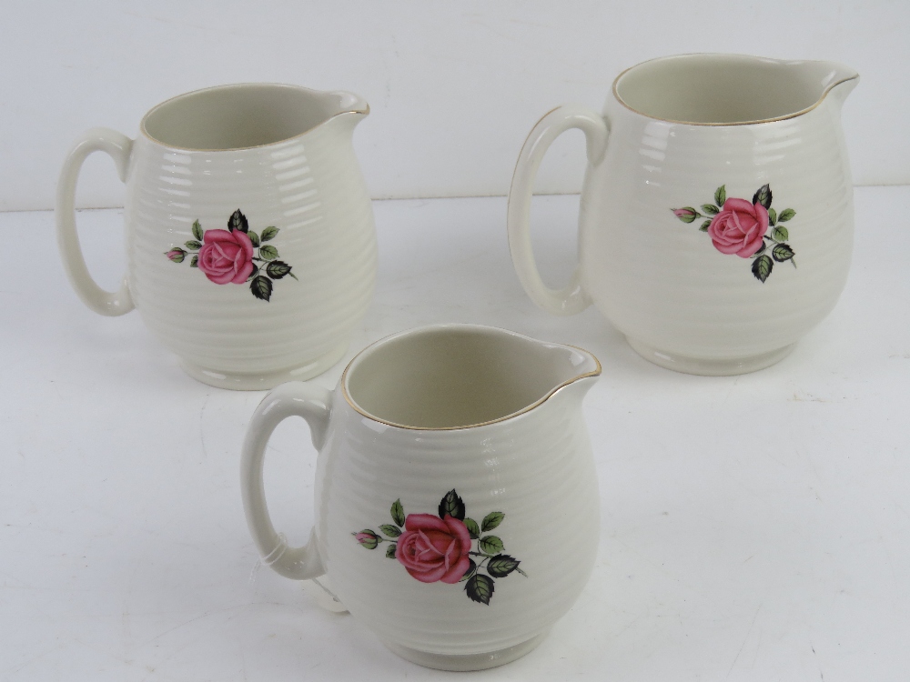 A set of three graduated Beswick chintz creamware jugs having pink floral design upon. - Image 3 of 3