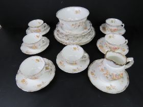 A part tea service having floral pattern on white ground with gilded rim inc bowl, tea cups,