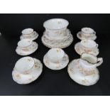 A part tea service having floral pattern on white ground with gilded rim inc bowl, tea cups,