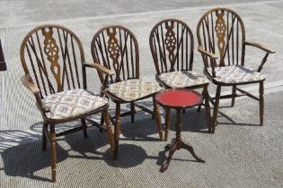 A set of four (2+2) wheel back dining chairs c1950s, raised over spindle turned legs.
