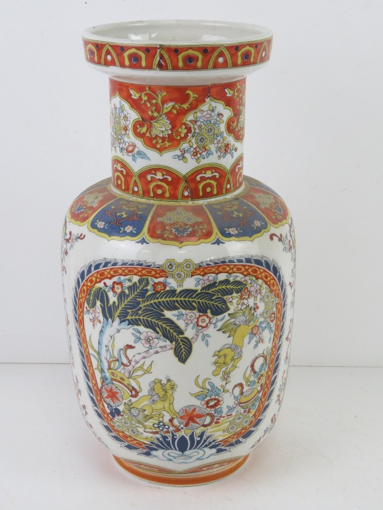 A contemporary Chinese influence vase in white ground with blue and orage decoration and Fo dogs