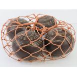 Four lignum vitae balls / boule in string carry bag.