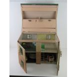 A mid century dolls house having opening windows and door, some furniture within, 50cm wide.