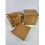 Two contemporary oak effect storage boxes each 25 x 25 x 25cm.