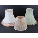 Three assorted silk lamp shades.