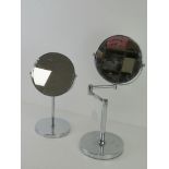 Two chromed magnifying shaving mirrors.