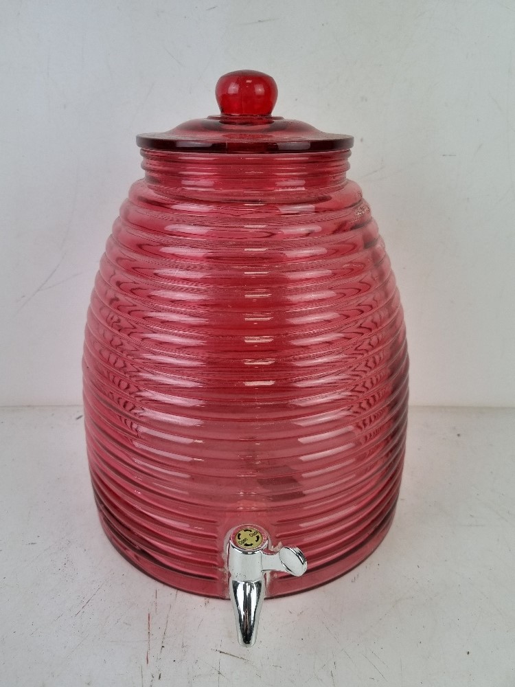 A pink glass kilner type drinks dispenser.