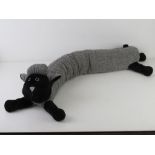 A draught excluder in the form of a black-faced sheep.