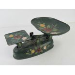 A hand painted canal or barge wear type set of scales in green ground with floral pattern upon.