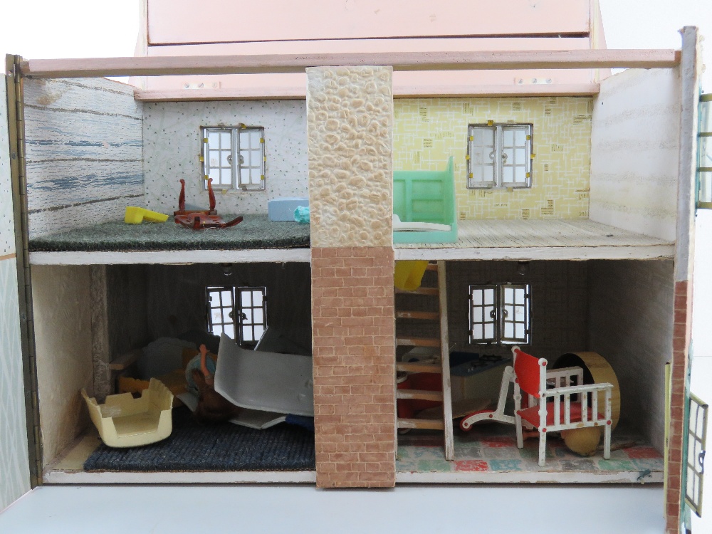 A mid century dolls house having opening windows and door, some furniture within, 50cm wide. - Image 2 of 4