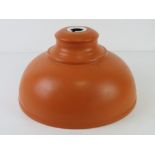 A contemporary orange painted industrial lamp shade, 29cm dia.