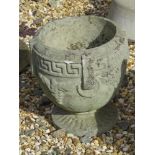 A pre-cast Greek key Bacchus style urn planter, 27cm high, 23cm wide.