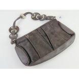 A brown cow hide and leather handbag by