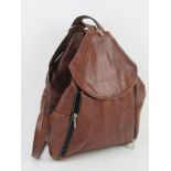 A vintage brown leather rucksack marked