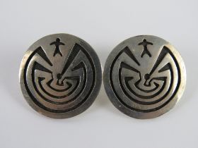 A pair of Native American sterling silver earrings having designer mark Puhuhoiya, 2.7cm dia.