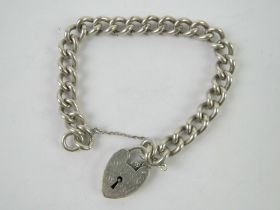 A heavy HM silver charm bracelet having heart padlock clasp, clasp stamped silver,