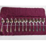 A set of twelve HM silver spoons in roll, hallmarked London 1824 and bearing maker's mark 'JH'.