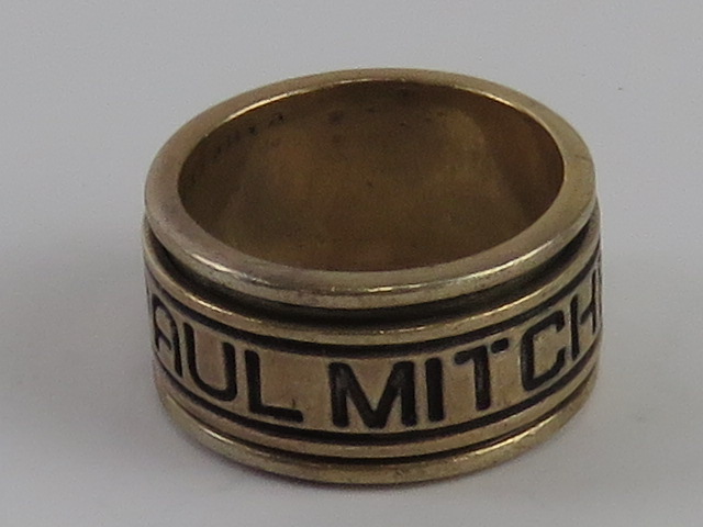 A silver ring by Paul Mitchell having slightly worn marks within, stamped 925, size R-S.