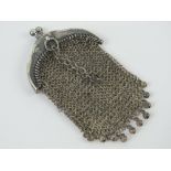 A white metal chain link purse having chain loop handle, no apparent hallmarks, approx 7.5 x 4.5cm.