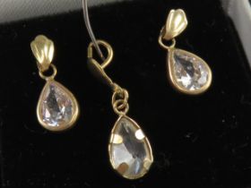A suite of jewellery comprising earrings and pendant, white teardrop shaped stones,