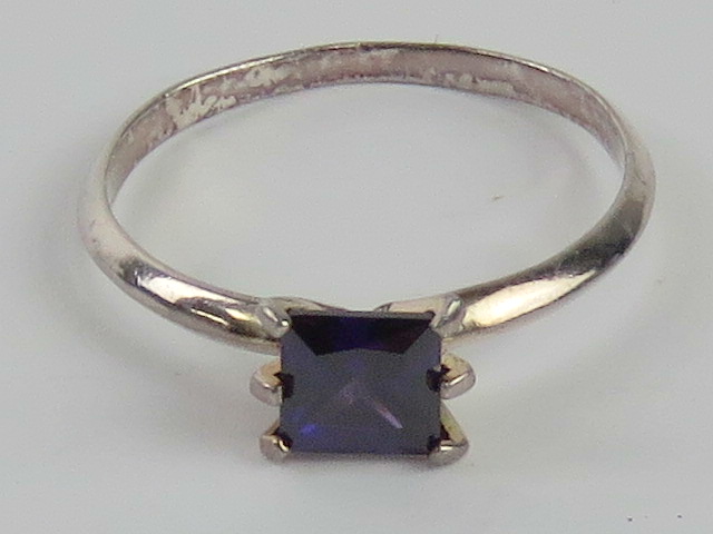 A silver ring having square cut purple stone, stamped 925, size U.