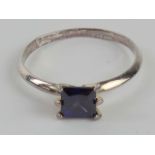 A silver ring having square cut purple stone, stamped 925, size U.